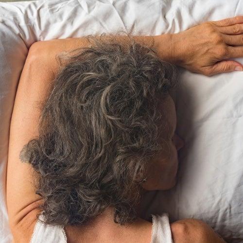 Woman sleeping on her stomach seen from above