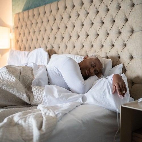 Woman sleeping on the bed at home.