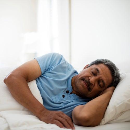 A man lying on his side sleeping peacefully