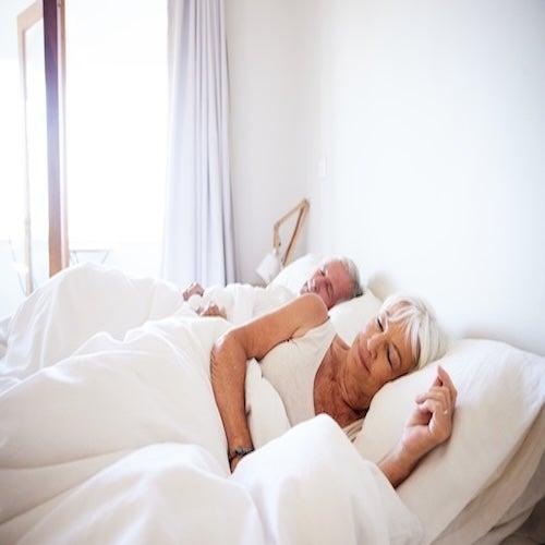 A couple sleeping peacefully in bed