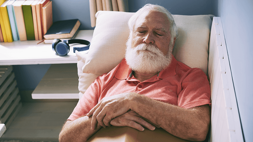 older bearded man asleep on couch