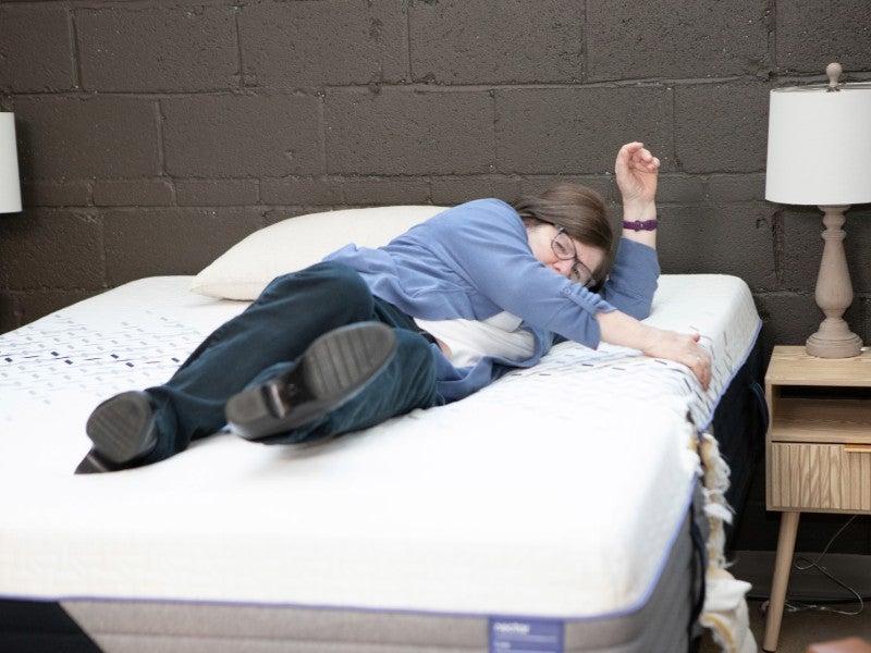 A woman struggles to turn over on a dense foam mattress