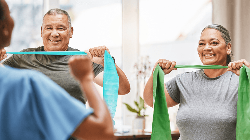 older man and woman following PT for band exercises