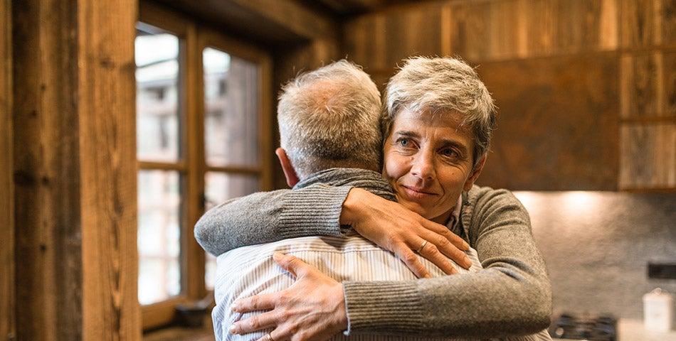Older woman hugging older man