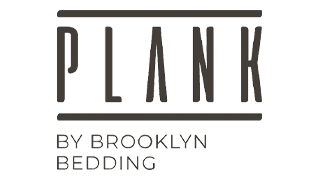 Plank firm mattress on raised bed frame with pillows