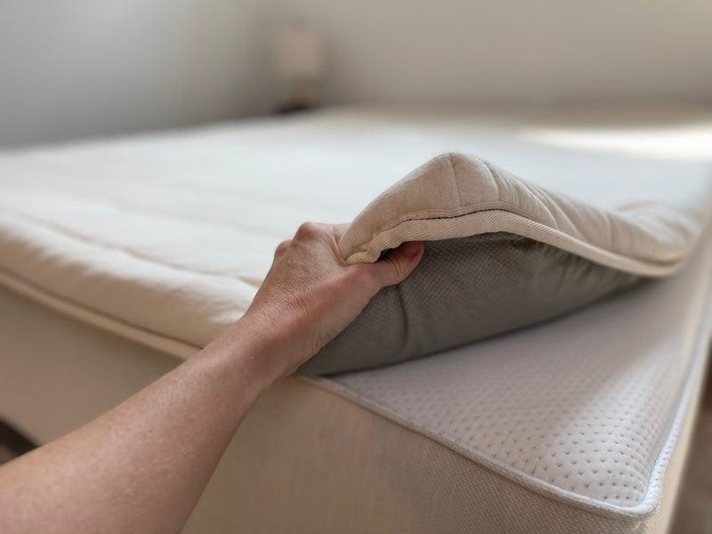 A tester shows the plush materials of the Birch Plush Organic topper.