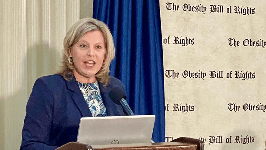 Ramsey Alwin at lectern with The Obesity Bill of Rights on background banner
