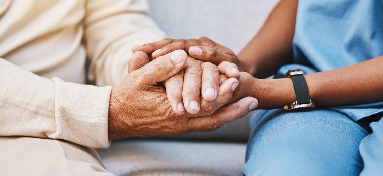 A caregiver and an older adult are hand-in-hand, close up. The stages of caregiving involve confusion and frustration as well as realization and acceptance. Take the time, periodically, to identify and acknowledge which stage in the caregiving journey you are in.