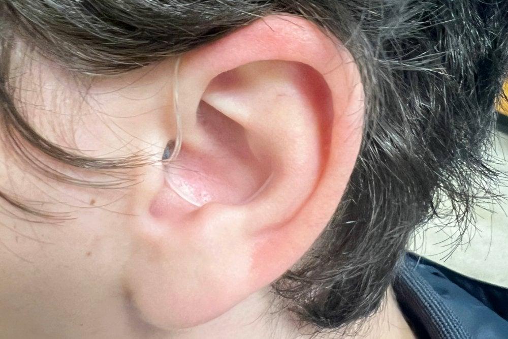 Jabra hearing aid with sport lock in man's left ear