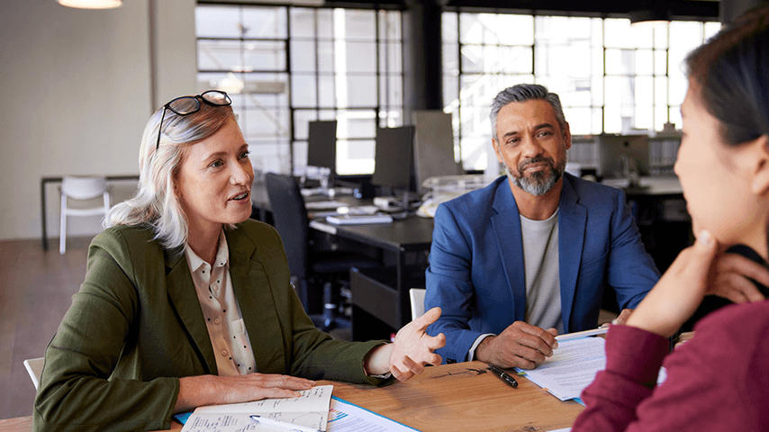 man and woman interviewing woman job candidate