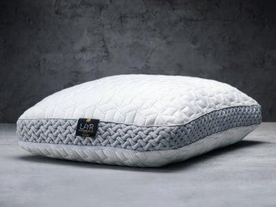 A Luxome LAYR pillow on a grey background