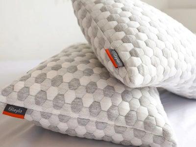 Two Layla Kapok pillows on a bed.