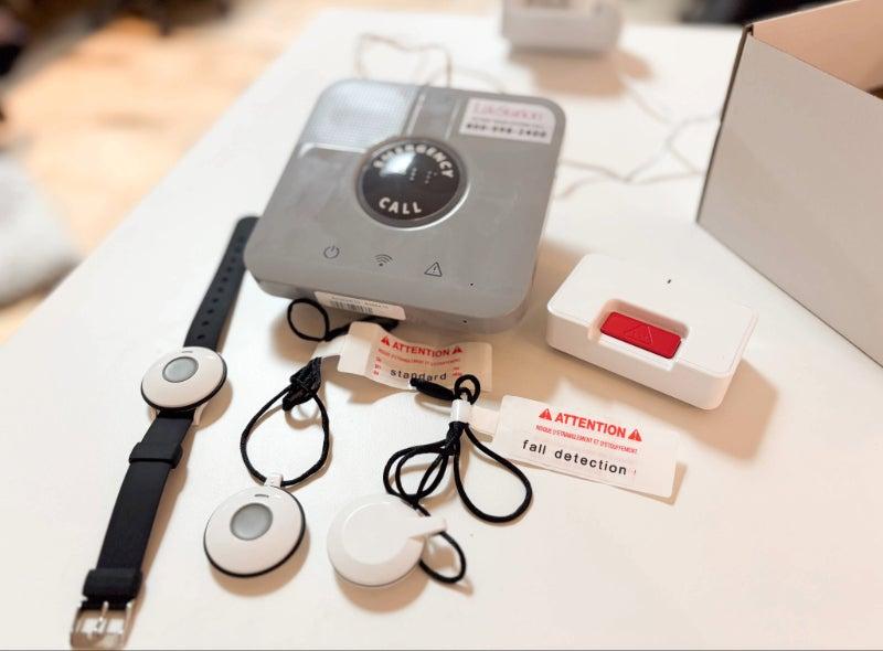 The LifeStation Sidekick Home, complete with wall buttons, a help button lanyard, and a wristband help button