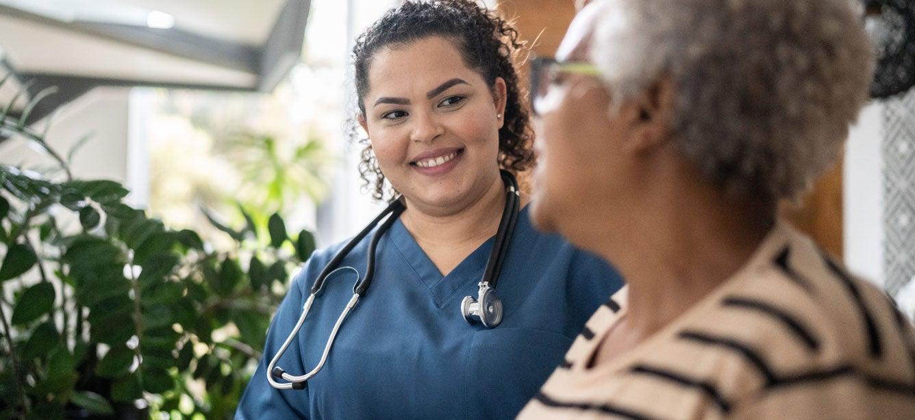A senior Black woman is receiving medical treatment in the hospital.
