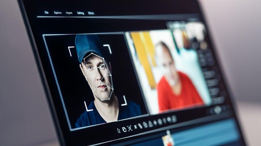 Close up shot of someone committing a deepfake scam by creating AI-generated photos, altering a white male's likeness.