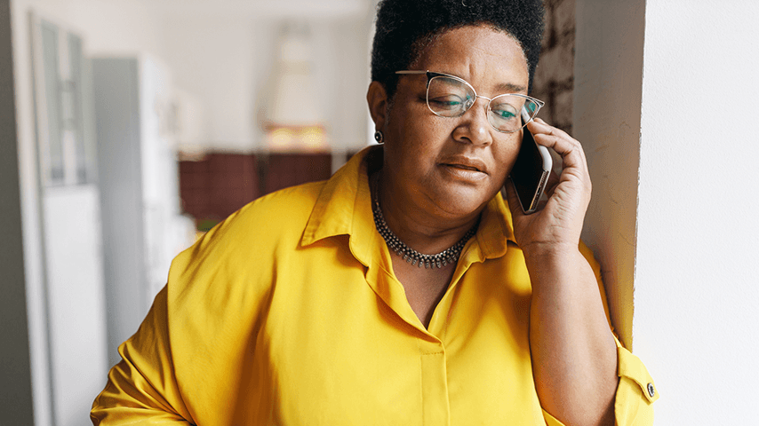 older woman holding phone to ear