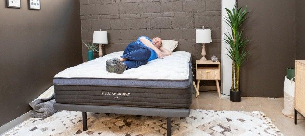 Man lies on his side on the Helix Midnight Luxe mattress