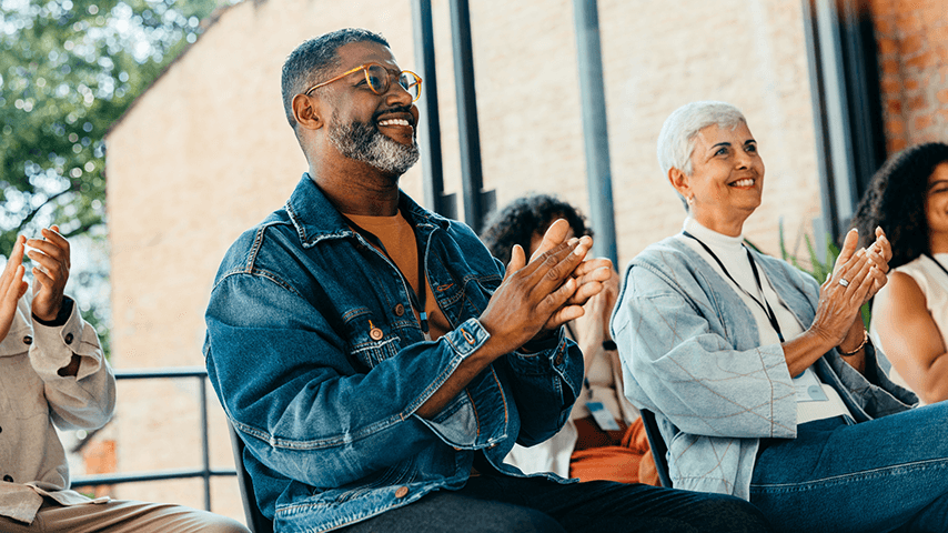 older black man and older white woman applauding