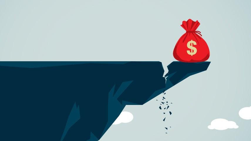 bag of money at the edge of a cracked cliff