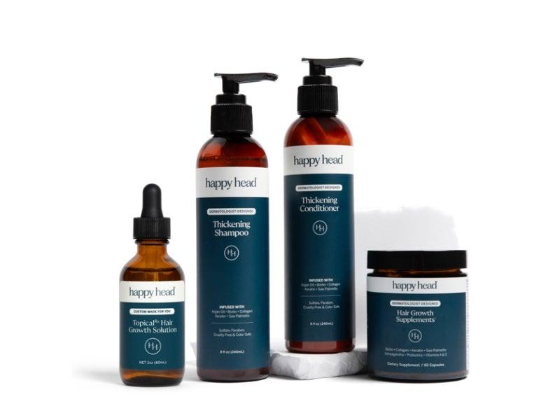The Happy Head Hair Growth Gift Set, including thickening shampoo and conditioner, hair growth supplements and a serum