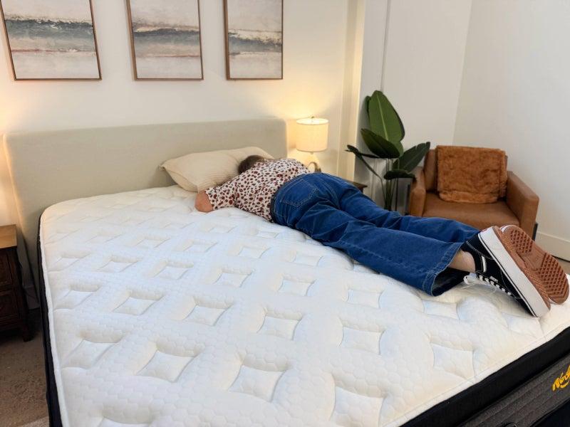 A woman lying on her stomach on the Nectar Evolution Comfort+ mattress
