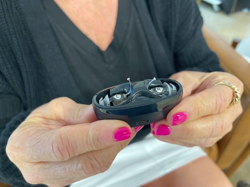 The Eargo SE hearing aids in their charging case.