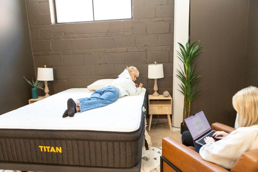 A woman lying on her stomach on the Titan Plus Luxe mattress