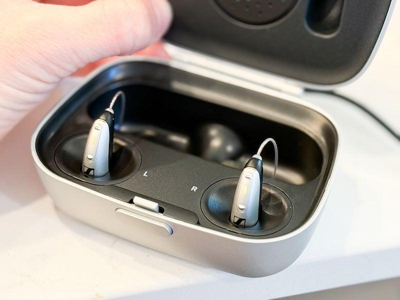 The Sennheiser All-Day Clear OTC hearing aids in their charging case
