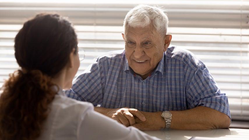Man sitting across the table from a woman.