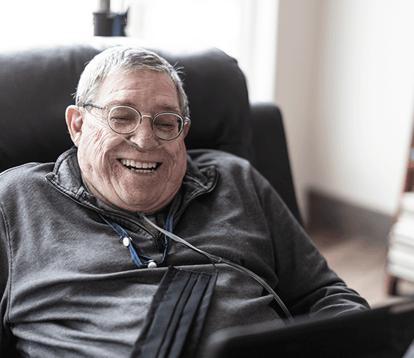 smiling older man wearing nasal cannula