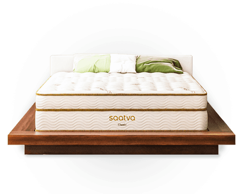 The Saatva Classic mattress on a wooden platform