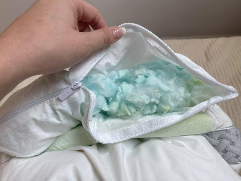 A tester displays the shredded latex and memory foam layers of the Luxome LAYR.