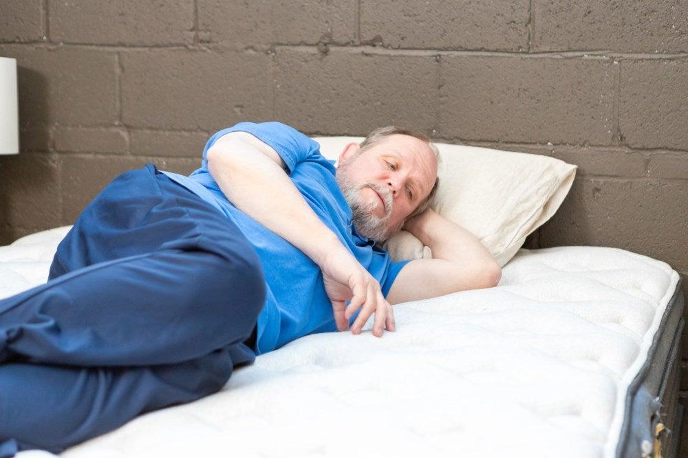 A man lying on his side on the Nolah Signature Mattress