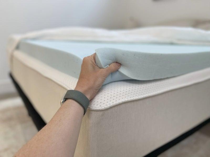 A person demonstrates the responsiveness of the memory foam
