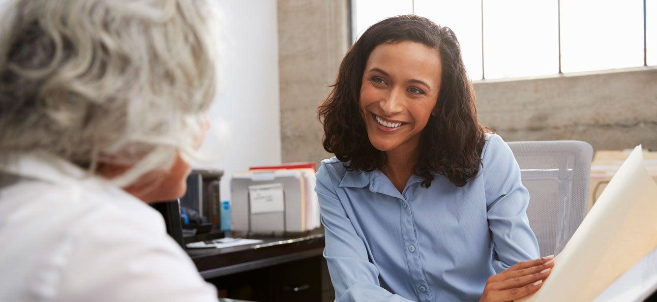 A senior woman is having a consultation with a professional regarding her work training.